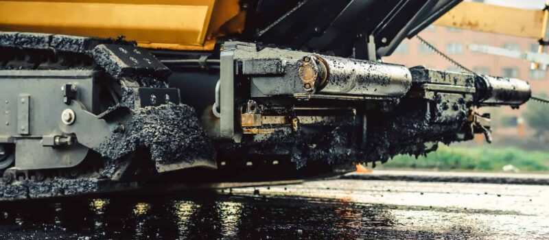 Road construction works with roller compactor machine and asphalt finisher